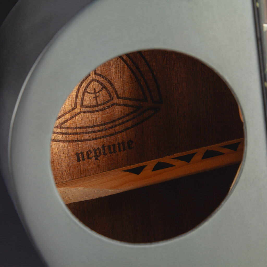 Offset soundhole with laser-cut hollow bracing visible inside