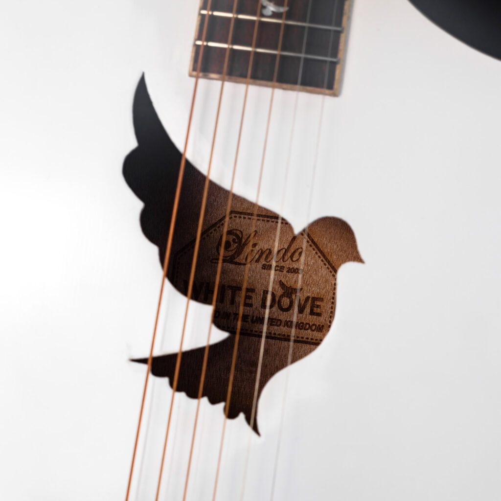 Dove-shaped soundhole in the gloss white body