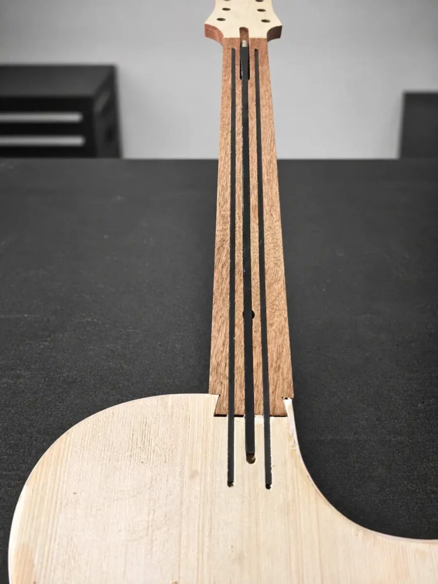 Twin carbon fibre reinforcement rods inside the new Lindo White Dove guitar neck
